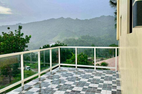 Tiled roof deck with glass railings overlooking the hills