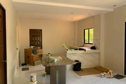 Kitchen with a stone-top island and marble-look counters