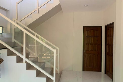 Glass-railed staircase and timber panel doors