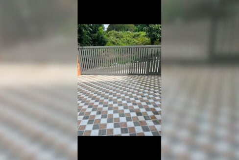 Tiled driveway behind a sliding gate