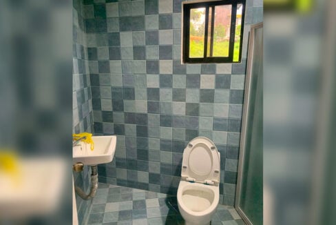 Bathroom with a shower enclosure and wall-hung sink