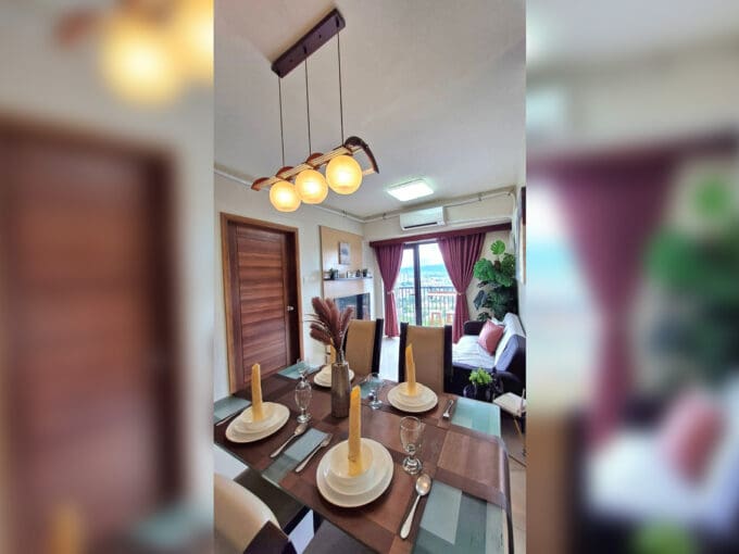 Dining area with pendant lights looking through to the living area and balcony in the 2BR at Soltana Nature Residences