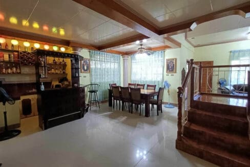 Bar counter and long dining table beside the staircase on the ground floor