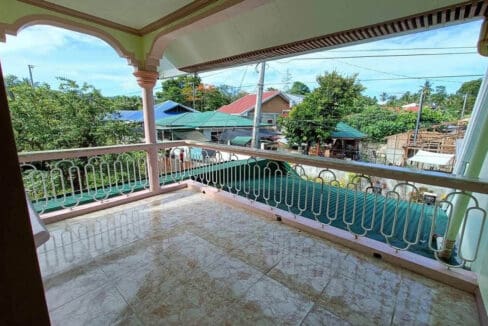 Tiled second-floor balcony of the house and lot for sale in Bohol, looking over the neighbourhood
