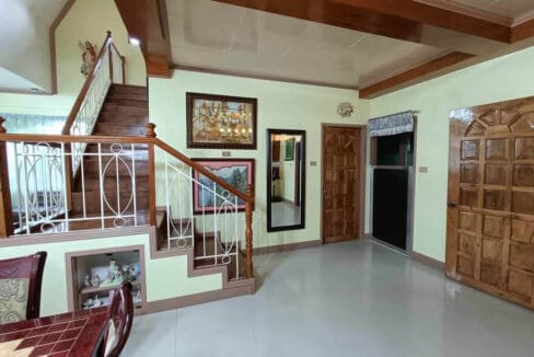 Timber staircase and hallway with panelled doors on the ground floor