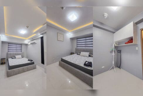 Bedrooms with upholstered bed, cove lighting and a wall-mounted cabinet in a high-floor Taft East Gate condo