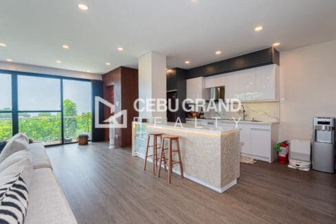 Open-plan living and kitchen with a marble-clad breakfast peninsula