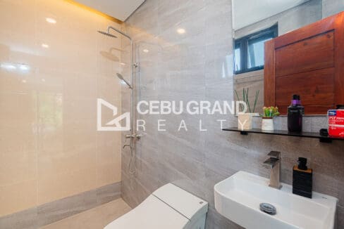Bathroom finished in large-format tile with a walk-in rain shower