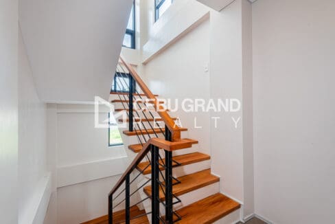 Staircase with timber treads and slim black steel balusters