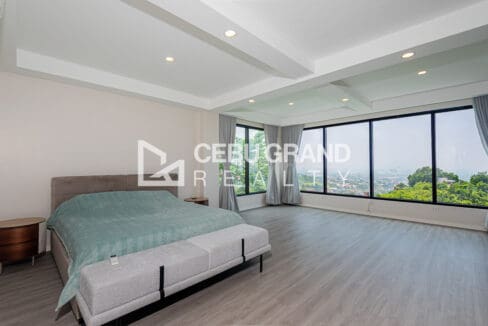 Master bedroom at the Vista Grande house with corner glazing over Cebu City