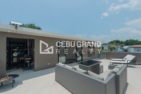 Roof deck with the storage room and grill area along the far wall