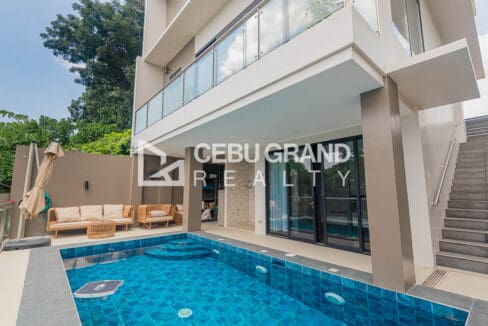 Private blue-tiled swimming pool below the glass-railed balconies of the Vista Grande house