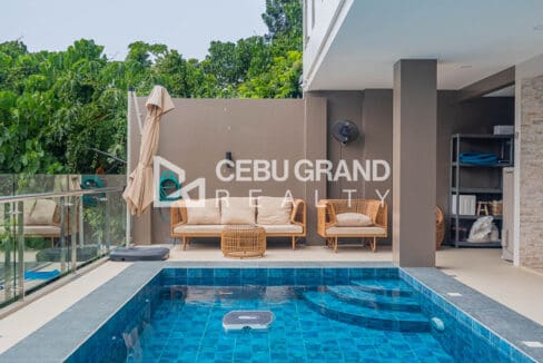 Covered poolside lounge area beside the swimming pool