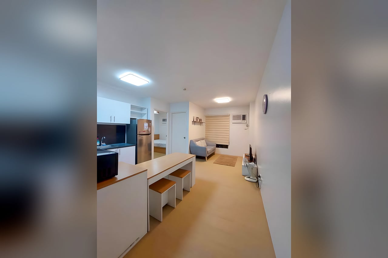 Furnished 1BR condo for rent at Avida Tower 2 with open-plan kitchen, dining counter and living area