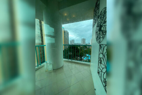 Second balcony with a teal railing and a view over the pool