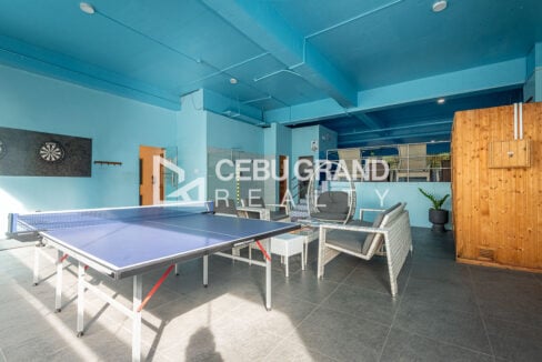 88th Avenue game area with table tennis, darts and wicker lounge chairs