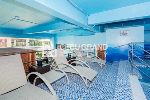 Sun loungers on the mosaic-tiled pool deck