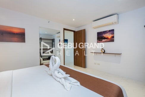 Bedroom with split-type aircon, full-length mirror and wood door