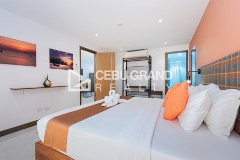 Bedroom with split-type aircon, wardrobe door and entry to the bathroom