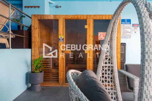 Wood-and-glass sauna beside the pool lounge
