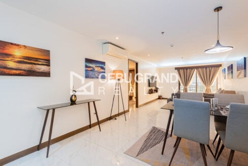Long living and dining room with a console table, tripod lamp and beach canvas art