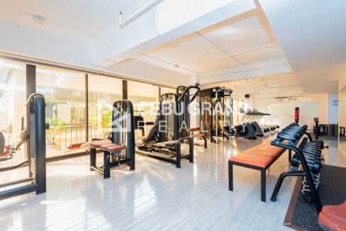 Gym with weight machines along floor-to-ceiling windows