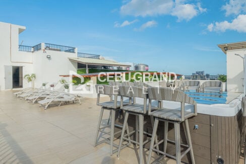 High-top bar counter and wicker stools on the roof deck