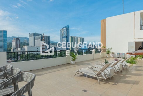 Roof deck lounge with sun loungers and Cebu City skyline views