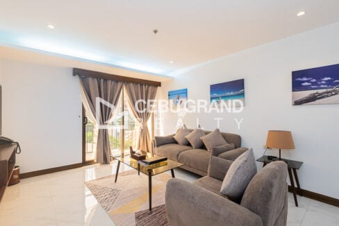 Sofa set, glass coffee table and balcony doors with full-length curtains