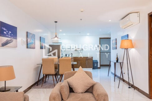 Dining table for four with the L-shaped kitchen behind