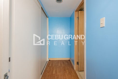 Walk-through closet with sliding wardrobes beside the master bathroom