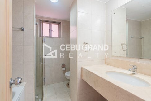 Master bathroom with marble-look vanity, glass shower enclosure and toilet