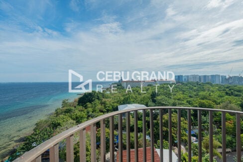 Balcony view over the coastline and resort buildings of Punta Engano