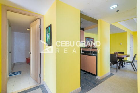 Hallway with service area door, kitchen and dining area