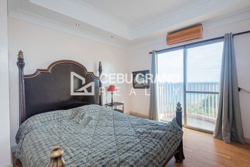 Third bedroom with four-poster bed and sliding door to a sea-view balcony