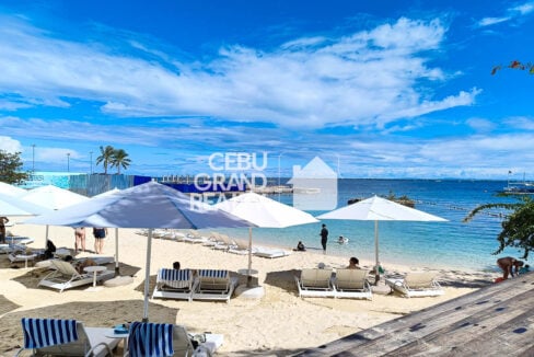 Movenpick Residences white-sand beach with sun loungers and umbrellas