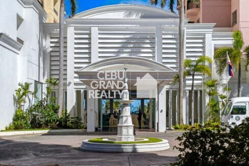 Movenpick Residences lobby entrance with fountain and palm trees