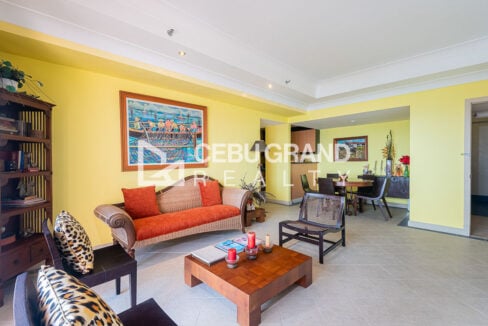 Rattan sofa, lounge chairs and dining area beyond in the Movenpick 3BR condo