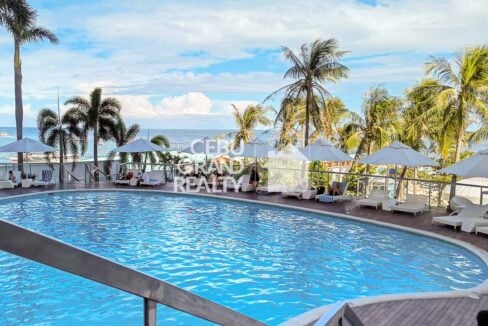 Movenpick Residences swimming pool with deck, loungers and sea view