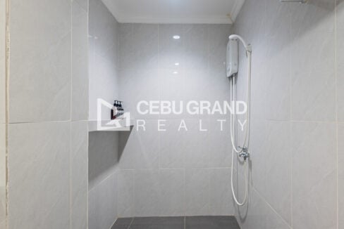 Tiled shower with a water heater in the en-suite bathroom