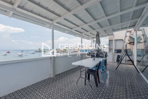 Covered veranda with patterned tiles and a view of the boats offshore