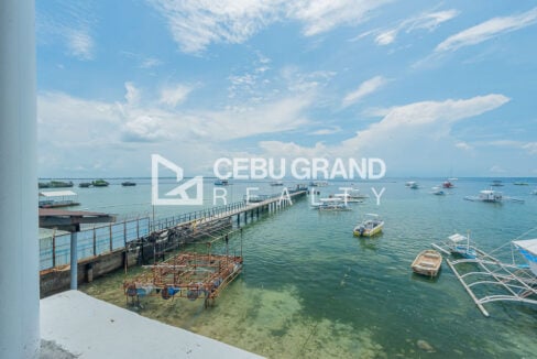 View of the jetty, boats and clear shallow water off Maribago, Mactan