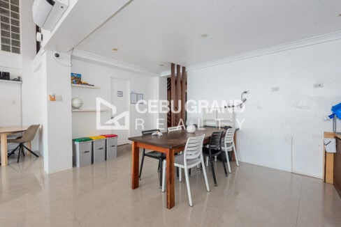 Lounge dining table with a refrigerator and kitchenette nearby