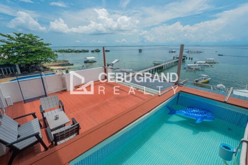Rooftop plunge pool and deck chairs overlooking the sea in Maribago, Mactan