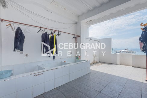 Tiled rinse tanks, wetsuit rack and outdoor showers beside the open seafront