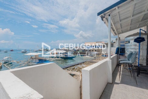 Seafront terrace overlooking moored bangkas and the water in Buyong, Mactan