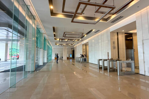 Wide lobby with full-height glass walls and security turnstiles at Cebu Exchange