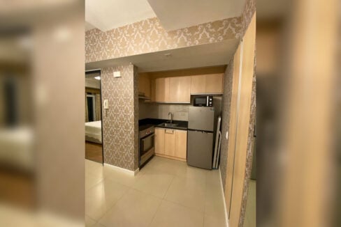 Kitchen with light wood-grain cabinets and two-door refrigerator