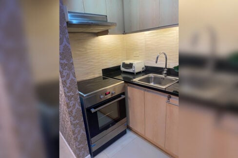 Electric range and oven beside a stainless sink