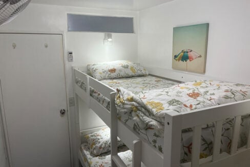 Bunk bed under beach-umbrella wall art